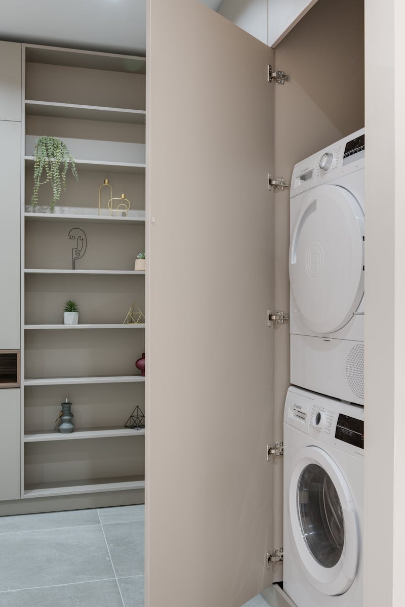 Modern washer and dryer set in home laundry closet